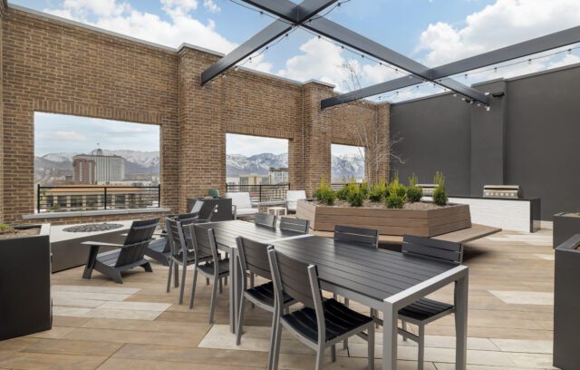 Rooftop lounge with tables and BBQs at The Register